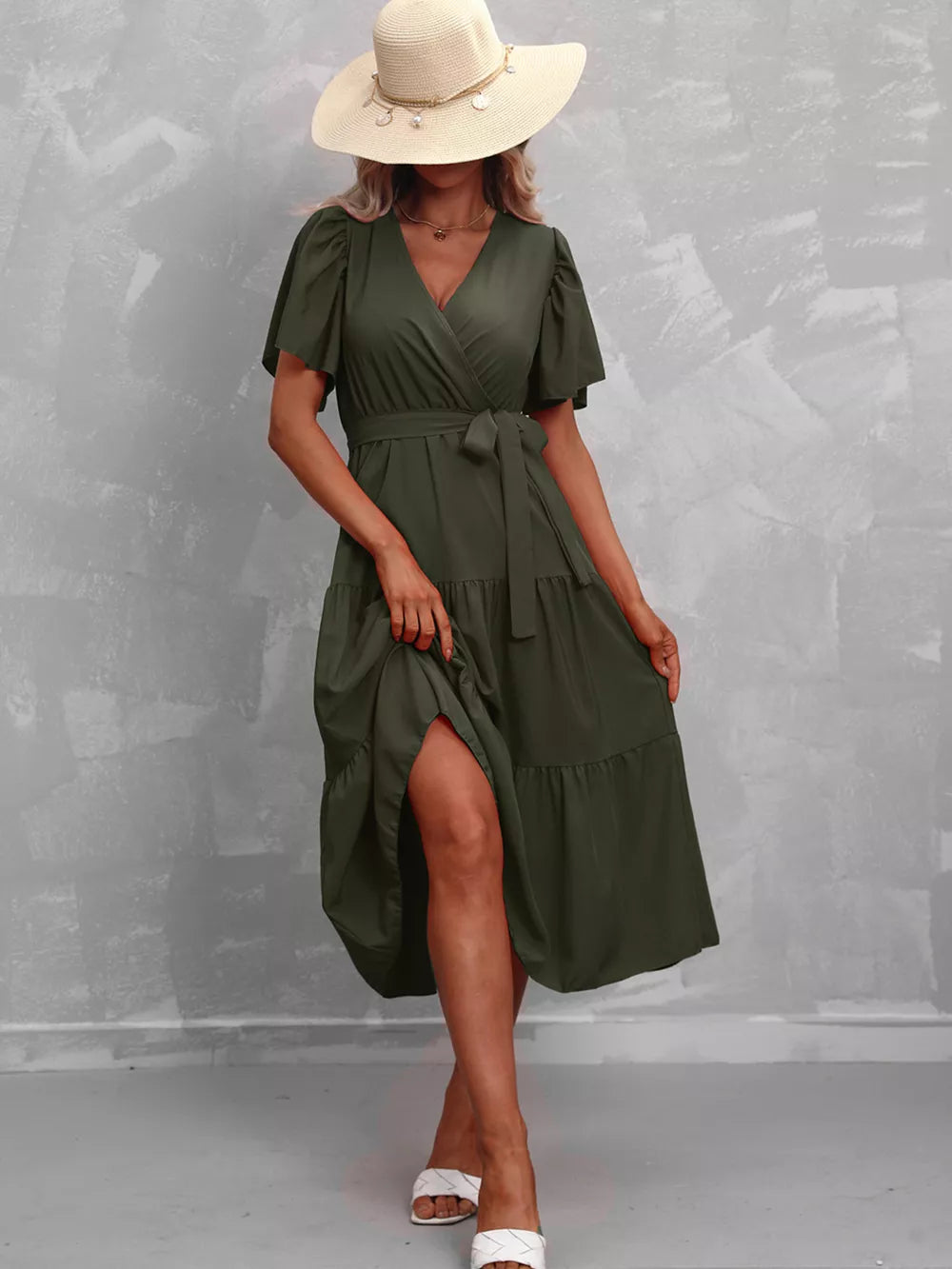 Dark green belted midi dress with flutter sleeves and tiered skirt.