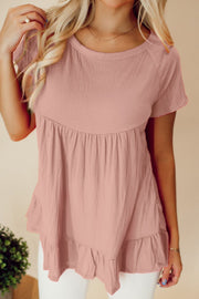 Dusty pink textured peplum top with ruffle hem and short sleeves.