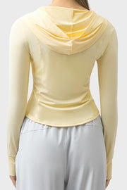 Light yellow active hoodie with thumbholes and a draped hood.