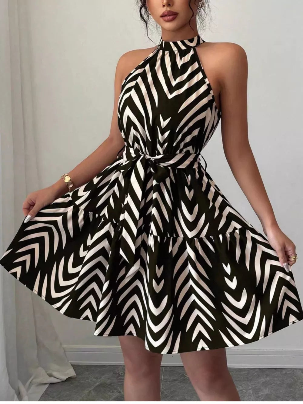 Chic halter neck tie-waist ruffle dress with black and white zebra print.