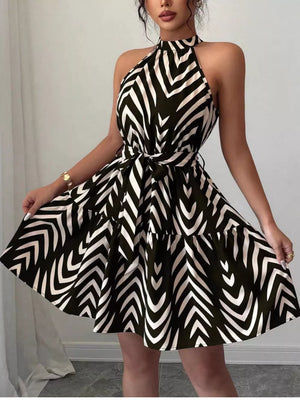 Chic halter neck tie-waist ruffle dress with black and white zebra print.