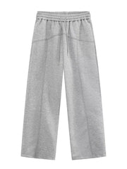 Gray cotton drawstring sweatpants with wide legs and seam details.