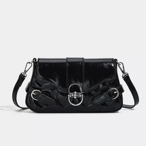 Black heart-quilted crossbody bag with buckle accent and silver hardware.