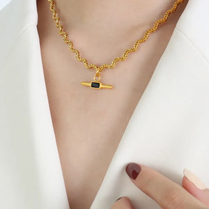 Gold rope chain necklace with black bar pendant