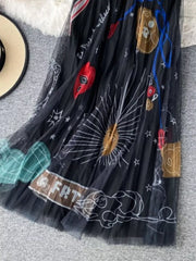Black tulle skirt with whimsical sunburst and abstract print, midi length