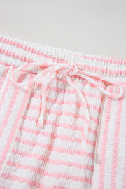 Textured stripe lounge shorts in blush pink and white with drawstring waist.