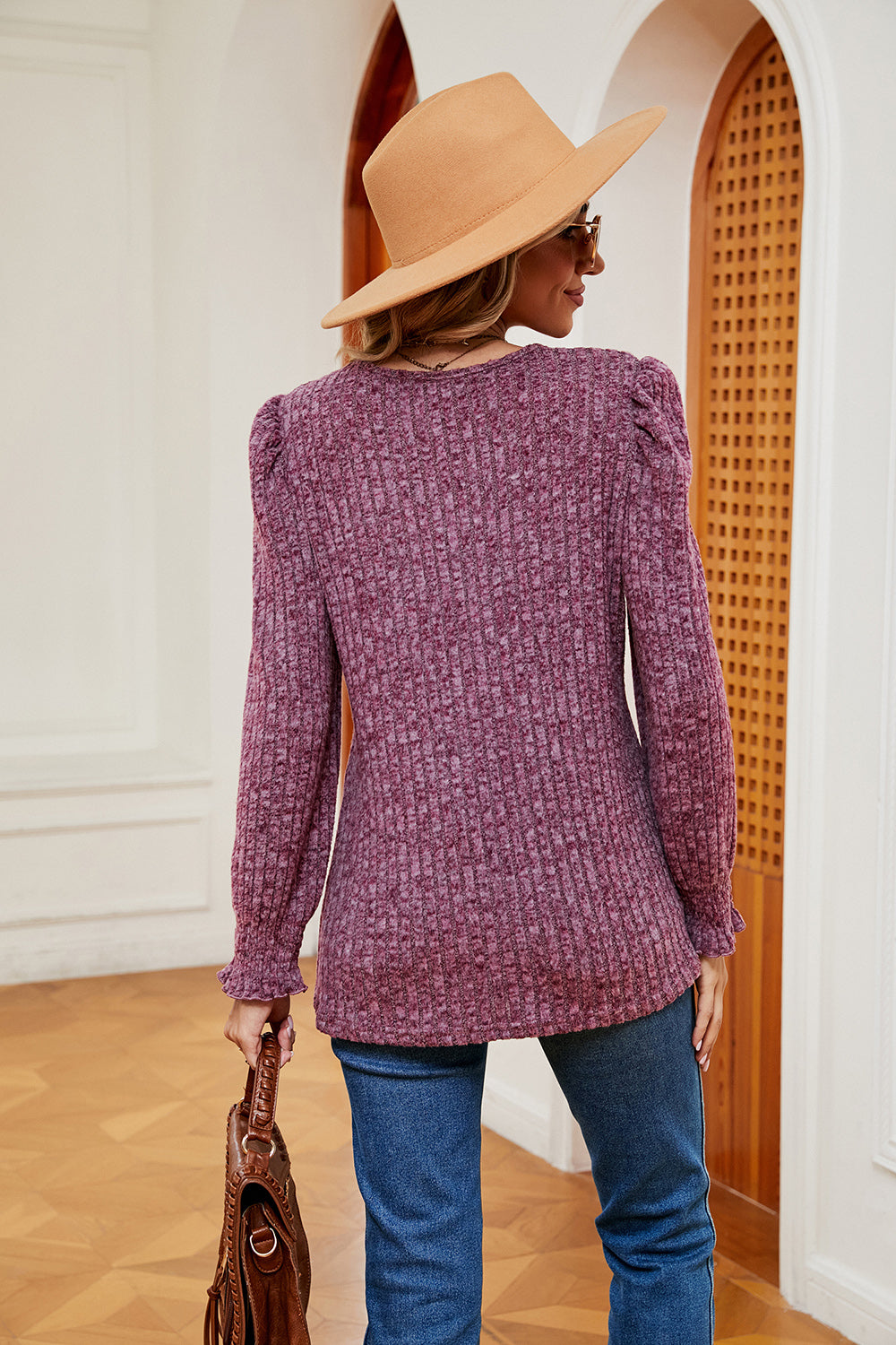 Textured knit blouse in fuchsia with square neckline, puffed shoulders, and ruffled cuffs.