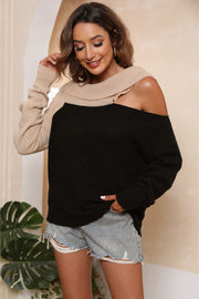Black and beige acrylic sweater with asymmetric neckline and boat neck.