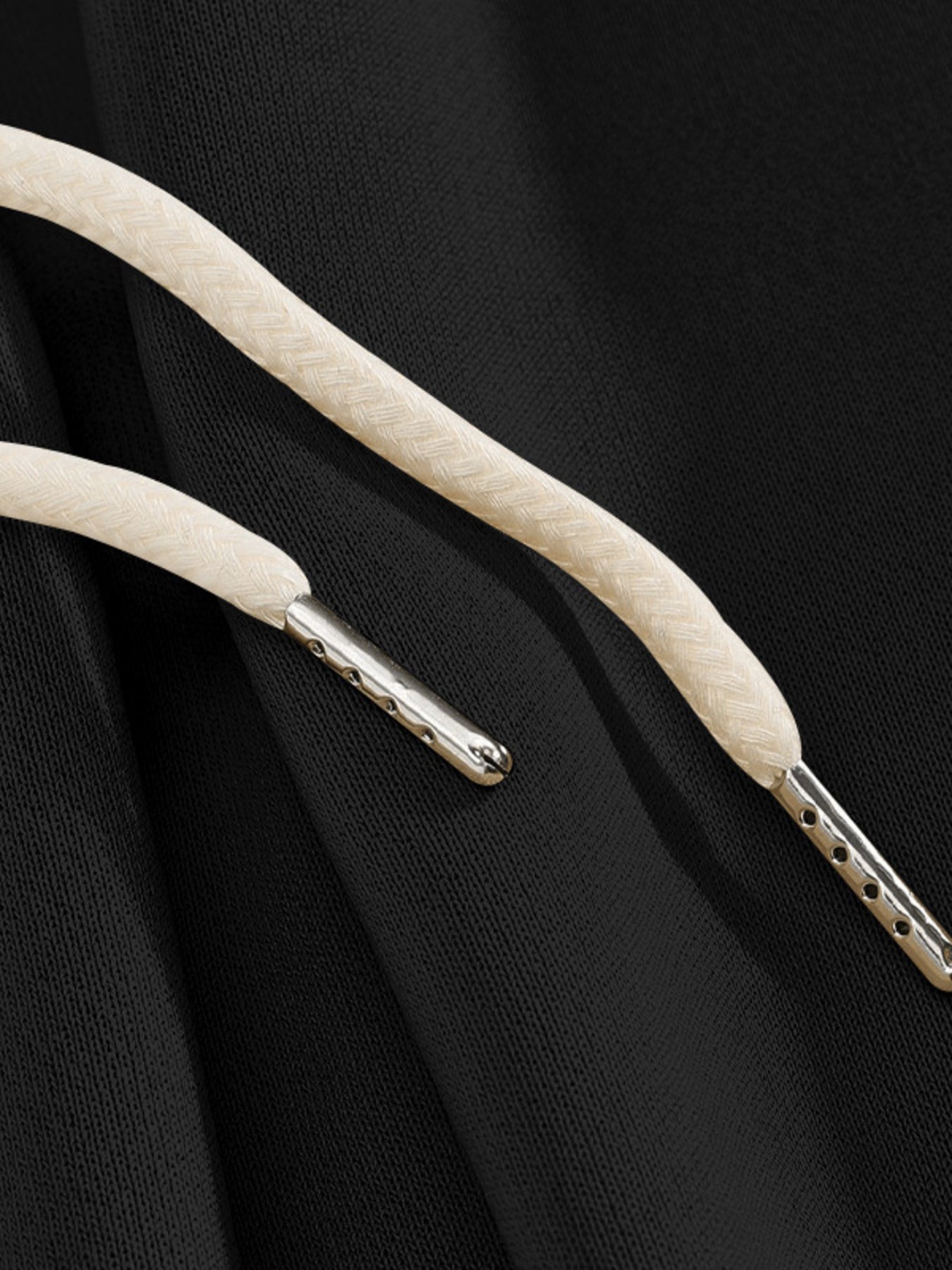 Black sweatpants with drawstring detail and metal-tipped aglets