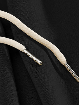 Black sweatpants with drawstring detail and metal-tipped aglets