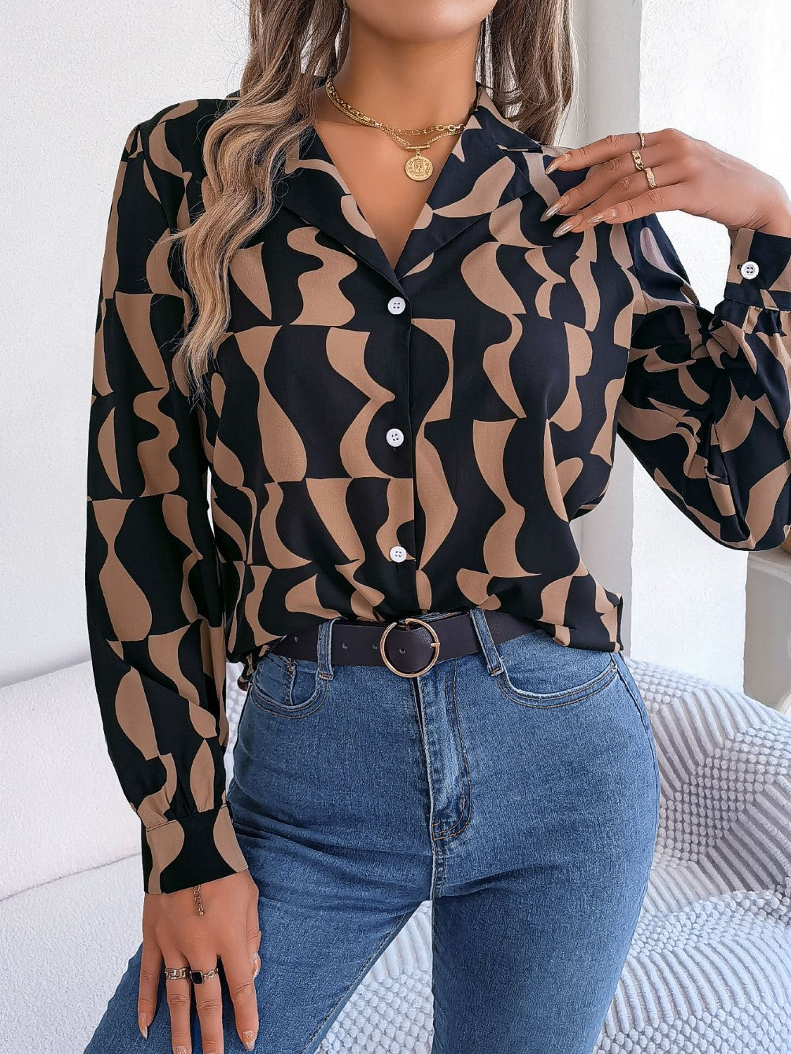 Black and tan abstract wave print silk-touch blouse with button front and collar.