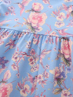Baby dress with floral hummingbird print on blue cotton blend fabric, featuring a ruffled hem.