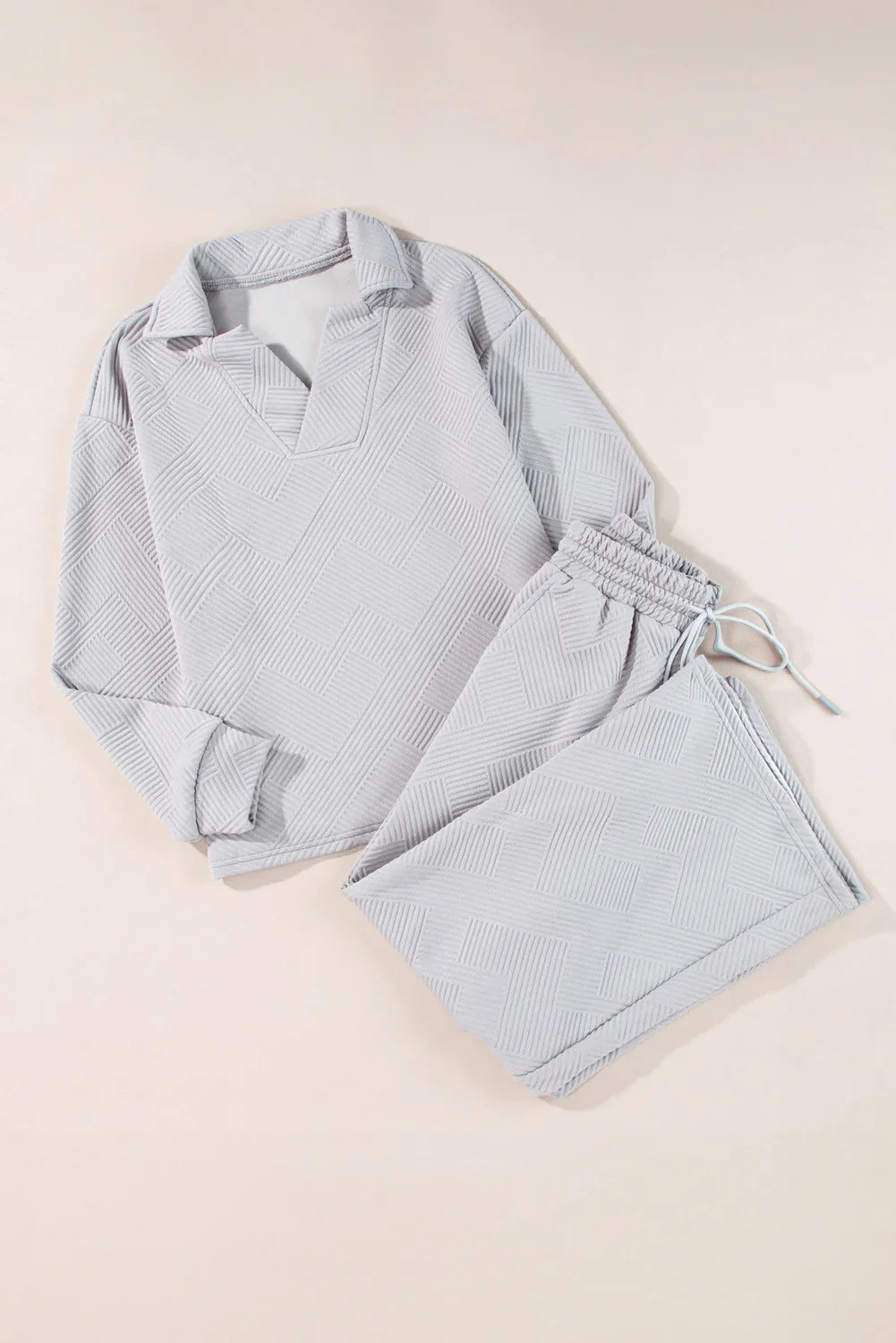 Gray textured quilted knit collared lounge set with v-neck and drawstring pants.