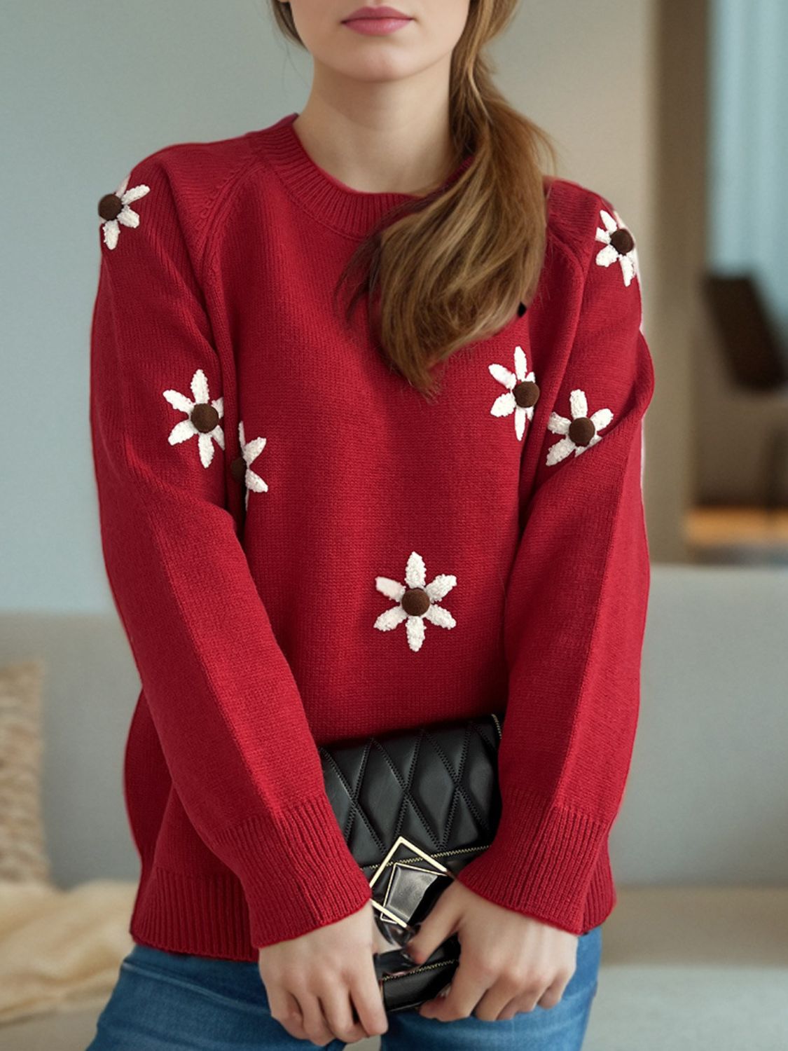 Burgundy raglan knit sweater with embroidered white floral details and brown centers.