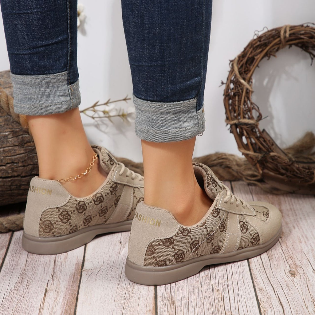 Chic beige lace-up sneakers with monogram pattern and "FASHION" detail.