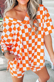 Orange and white checkered v-neck top and shorts set with short sleeves.