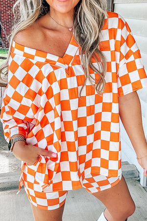 Orange and white checkered v-neck top and shorts set with short sleeves.