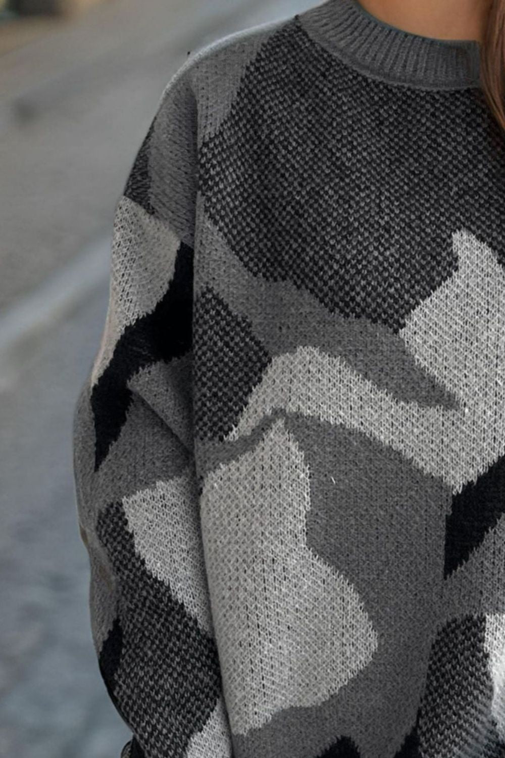Gray geometric knit crewneck sweater with colorblock pattern and acrylic material.