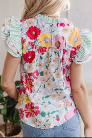 Floral ruffle sleeve blouse with a mixed floral print and green striped accents.