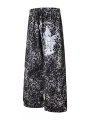 Leopard print cotton sweatpants with drawstring waist and wide leg, featuring a graphic print detail.