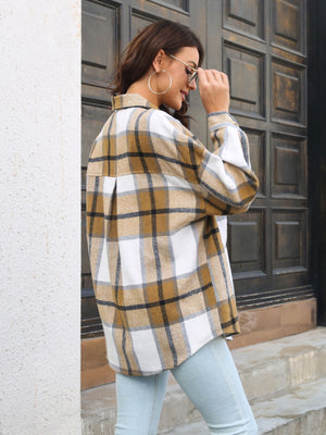 Oversized plaid shacket in khaki with gold buttons, featuring a relaxed fit and classic collar.