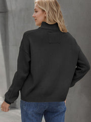 Black acrylic knit stand collar cardigan with ribbed details and a patch on the back yoke.