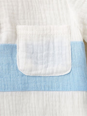 Children's cotton color-block top with a white pocket and blue stripe detail.