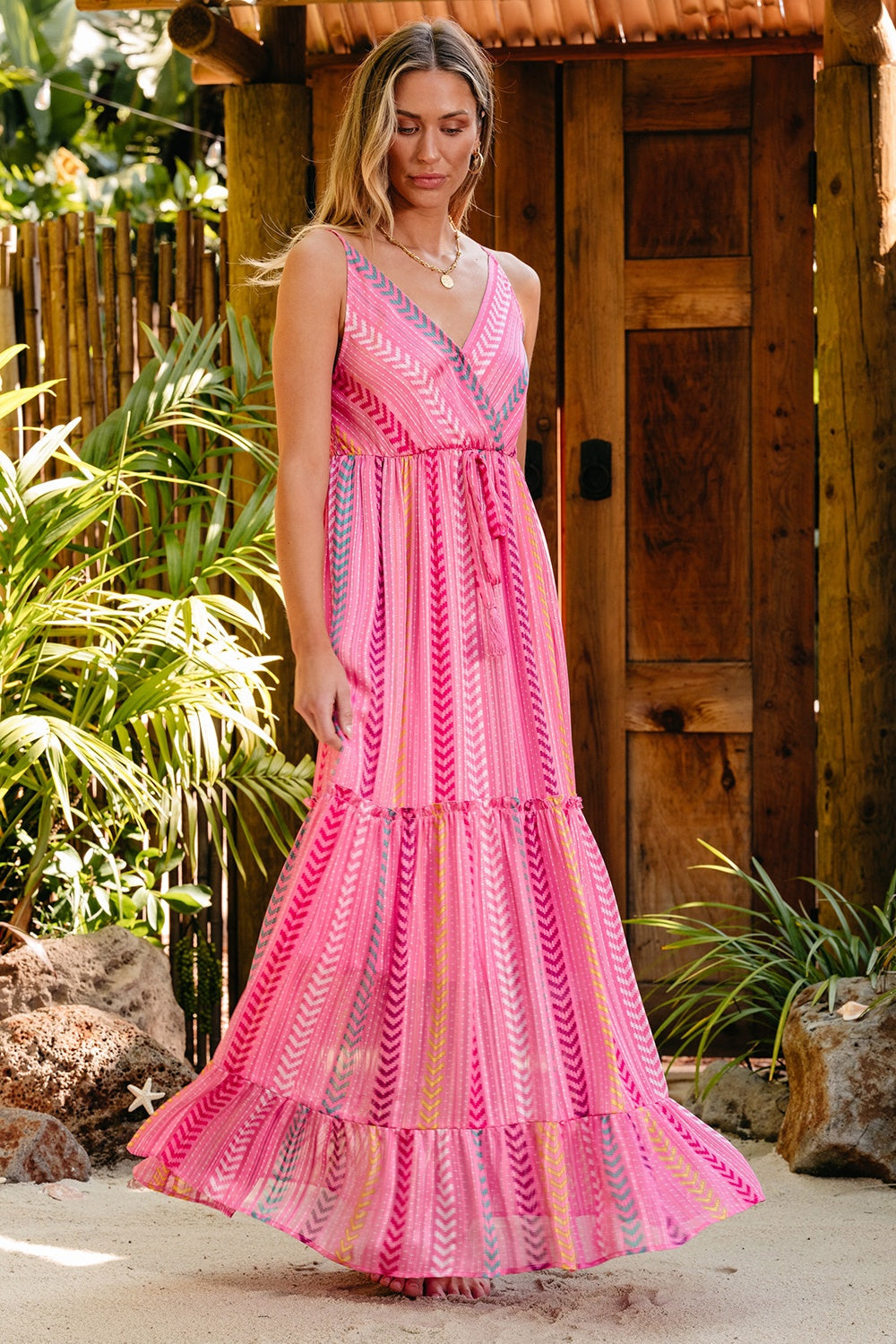 Pink chevron stripe tiered maxi dress with V-neck and tie waist.