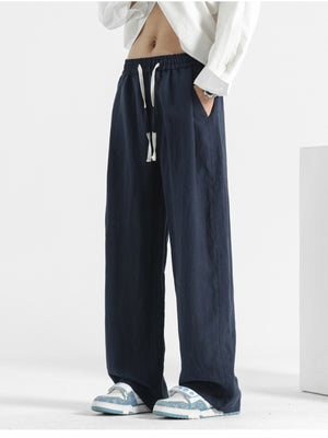 Navy blue loose fit drawstring pants with a relaxed cut.