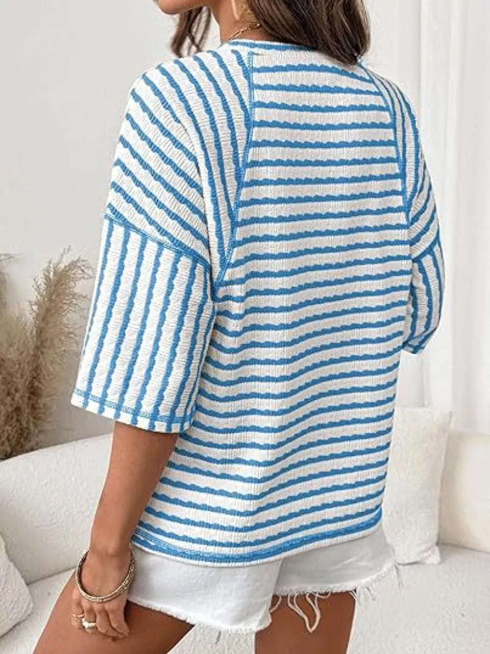 Light blue and white wavy stripe knit t-shirt with relaxed fit and short sleeves.