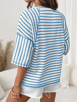 Light blue and white wavy stripe knit t-shirt with relaxed fit and short sleeves.
