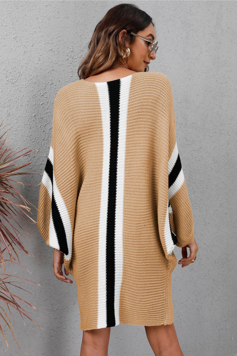 Oversized knit cocoon dress in khaki with black and white vertical stripes and sleeve stripes.