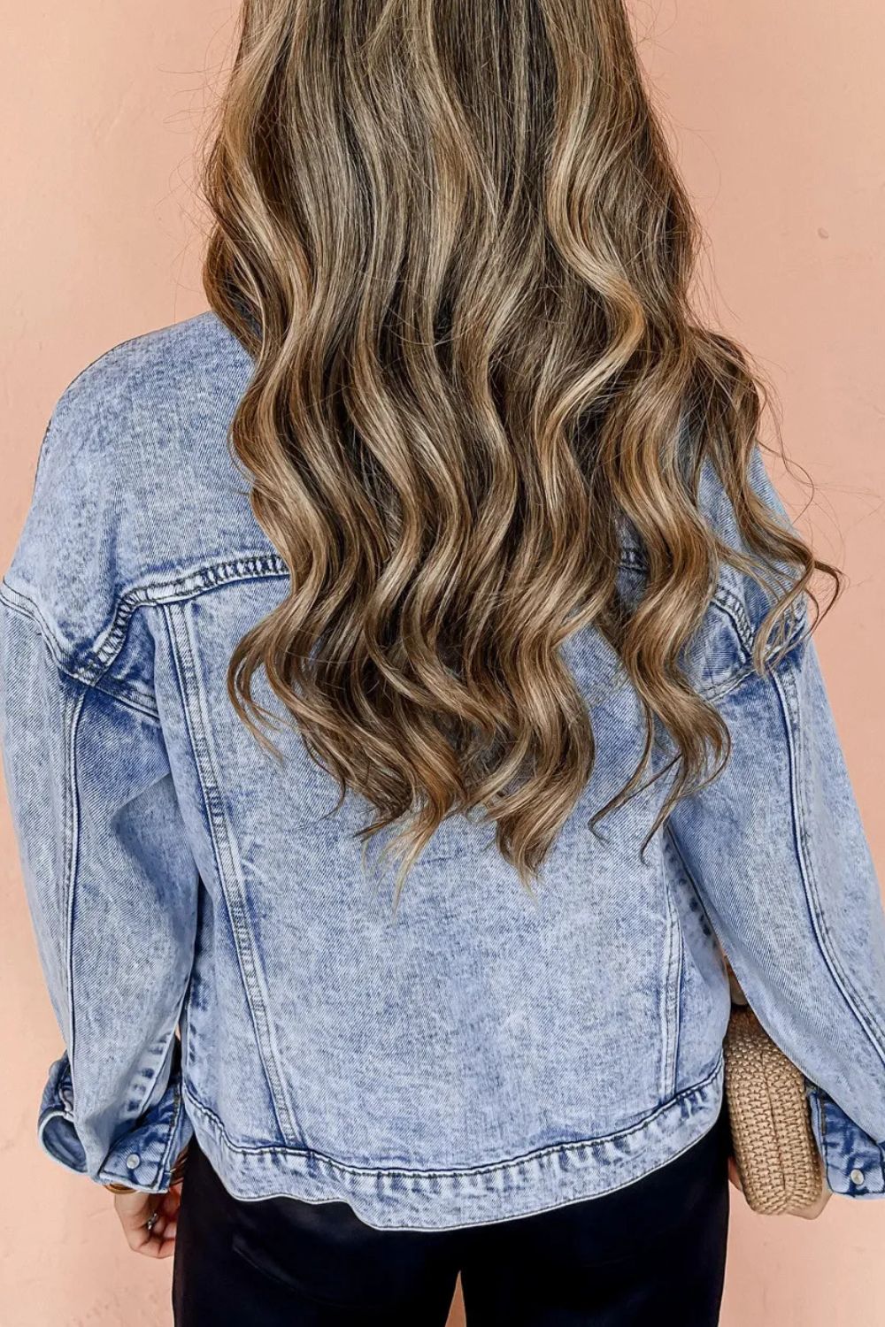 Acid wash denim jacket in medium, relaxed fit, cotton blend, with visible seams and button cuffs.