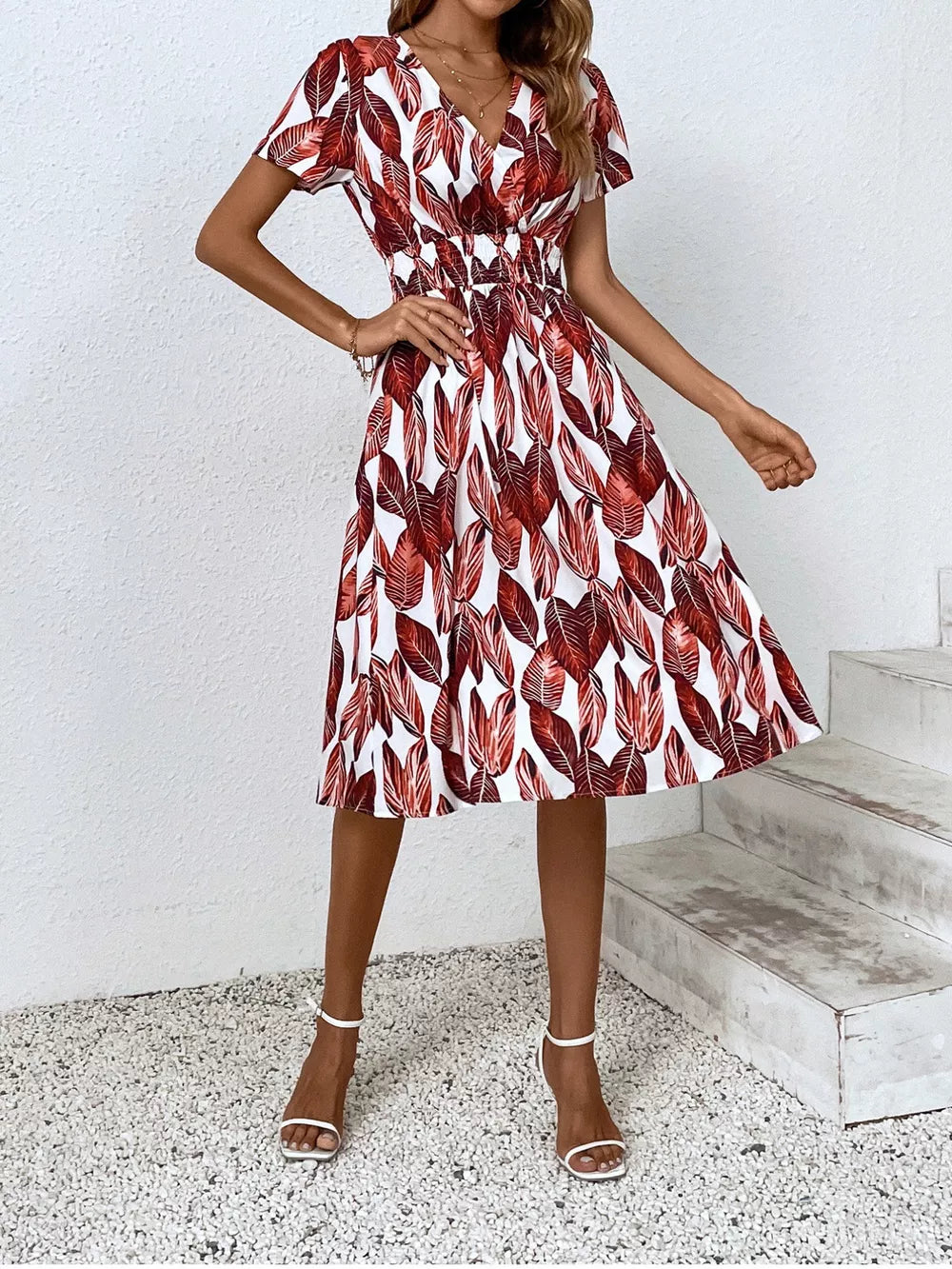 Red leaf pattern midi dress with v-neck, short sleeves, and elastic waist.