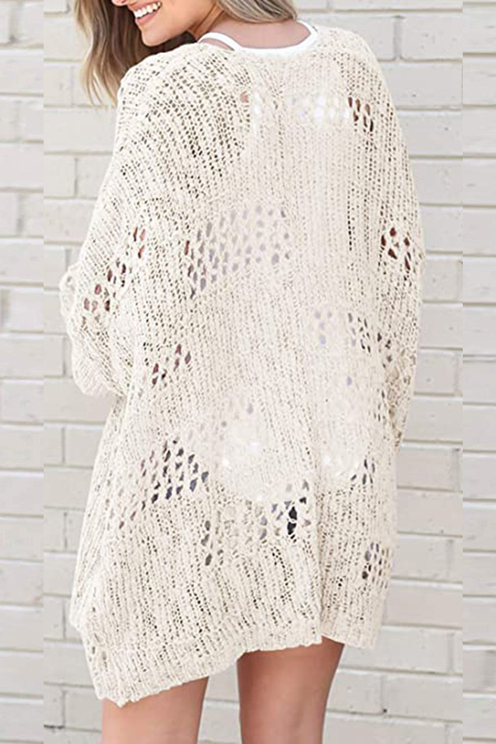 Cream open-knit slouchy cardigan with a relaxed fit and intricate cutout details.