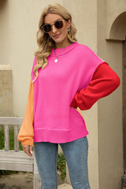 Colorblock knit pullover sweater in hot pink, red, and orange acrylic with a crew neck.