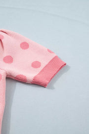 Pink polka dot knit cardigan with puff sleeves and ribbed cuffs.