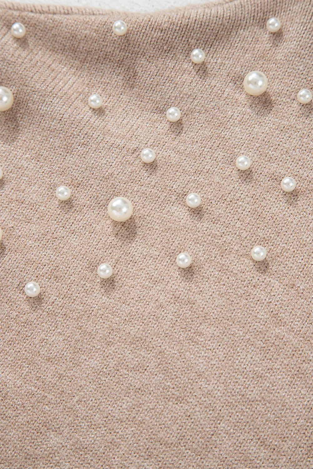 Dust Storm knit sweater with scattered pearl embellishments and balloon sleeves.