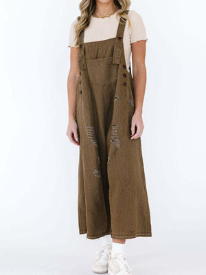 Brown ripped relaxed fit denim overalls with adjustable straps and button closures.