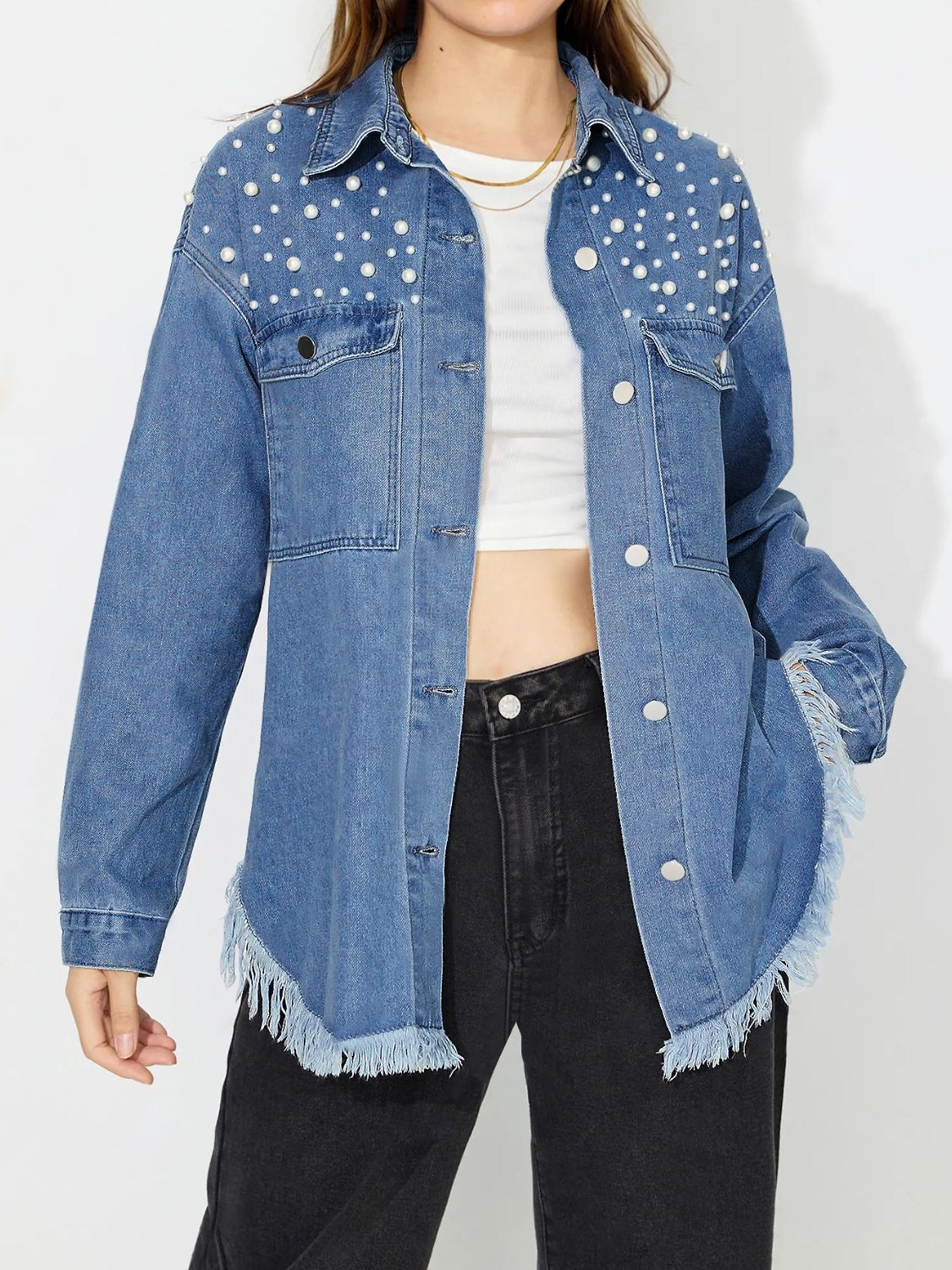 Medium wash denim shirt with pearl embellishments and frayed hem