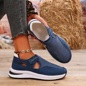 Navy mesh platform slip-on sneakers with cutout detail and white sole.