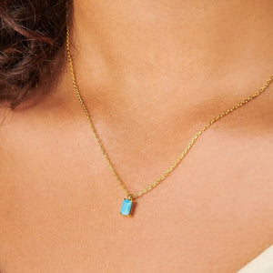 18K gold necklace with a rectangular blue gemstone pendant.