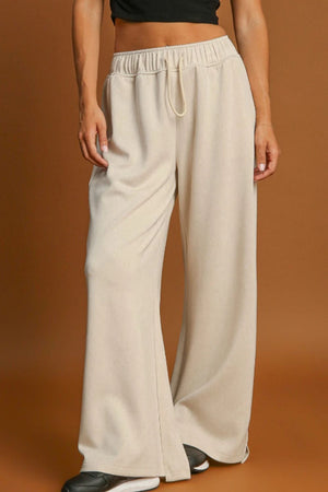 Beige wide-leg drawstring lounge pants with elastic waistband