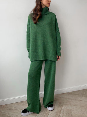 Oversized green acrylic turtleneck lounge knit set with wide leg pants.