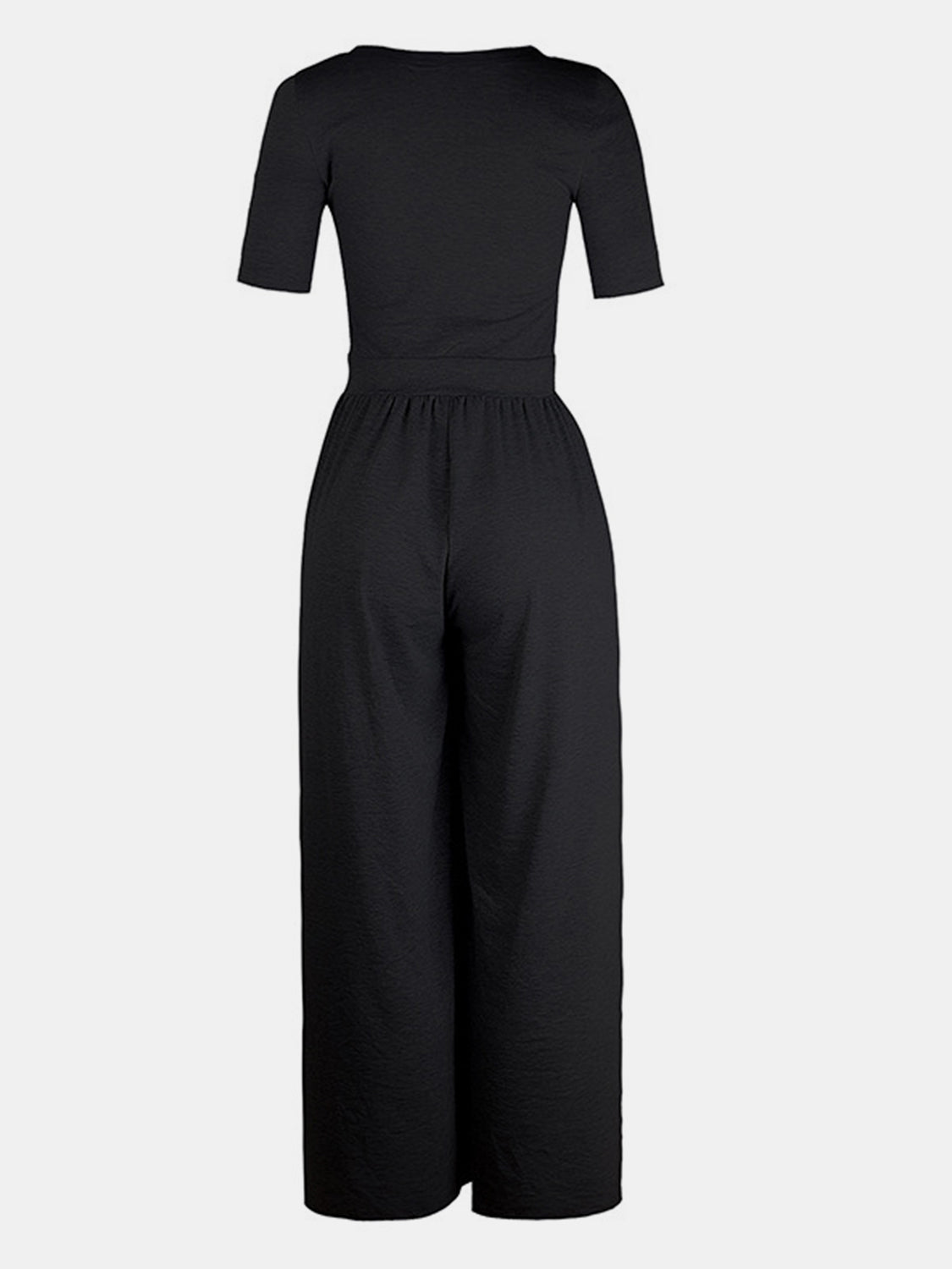 Black textured wide-leg maternity jumpsuit with short sleeves and a subtle elastic waist.