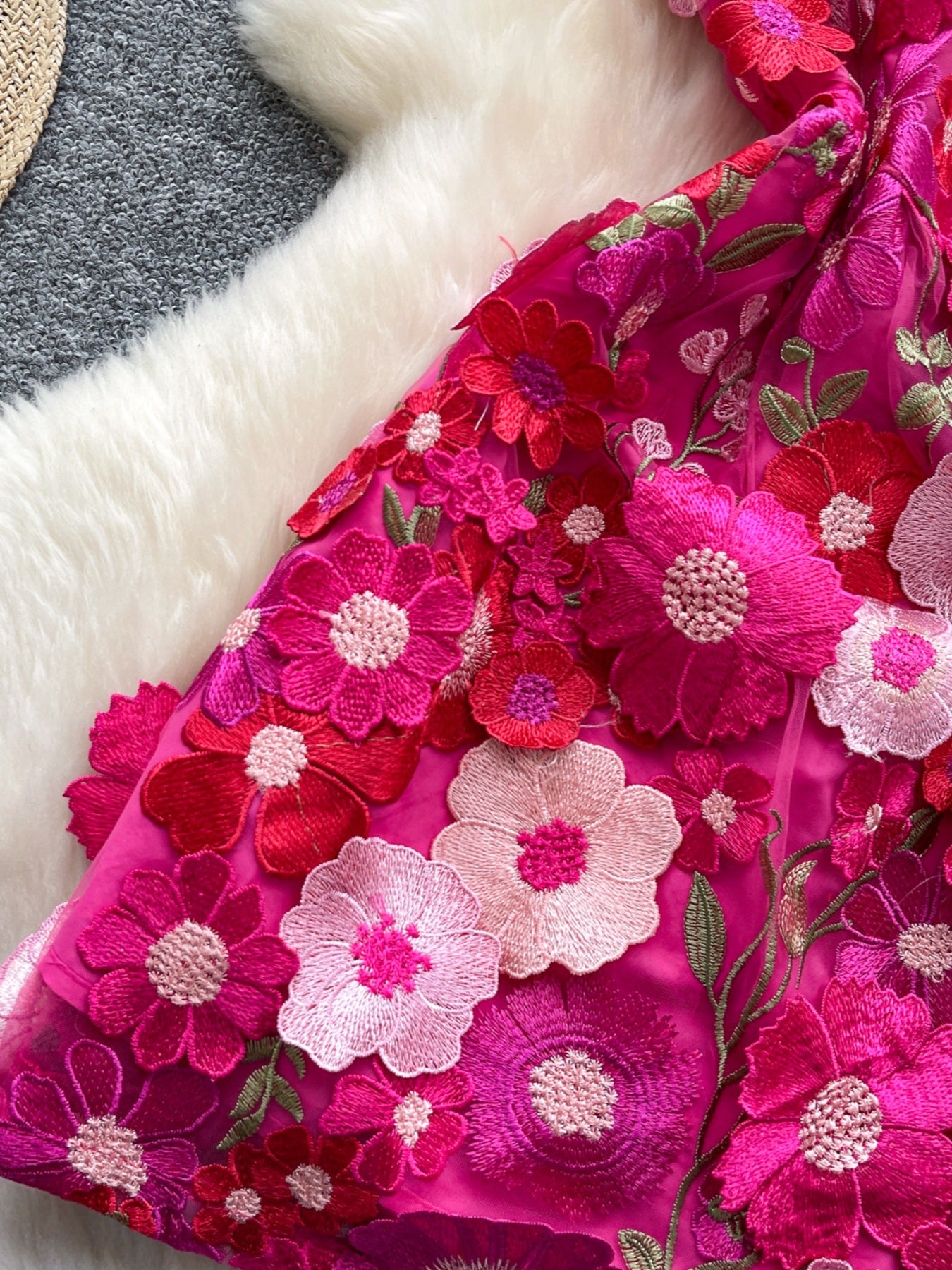 Embroidered floral mini dress in vibrant pink with 3D flower appliques and bow detail.