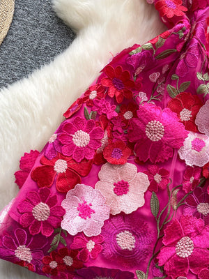 Embroidered floral mini dress in vibrant pink with 3D flower appliques and bow detail.