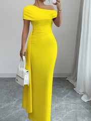 Yellow asymmetrical ruched maxi dress with off-the-shoulder neckline and body-hugging fit.