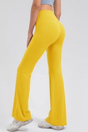 Yellow flare leggings with a performance fit and high waist, styled with sneakers.