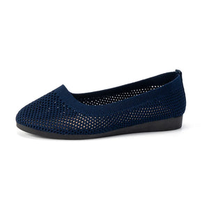 Indigo breathable knit ballet flats with a perforated pattern and flat sole.
